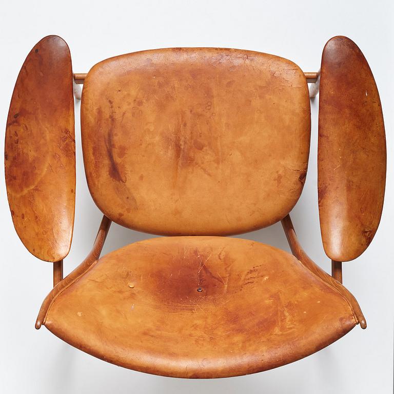 Finn Juhl, a teak and natural brown leather "Chieftain Chair" by Niels Vodder, 1950-60's.