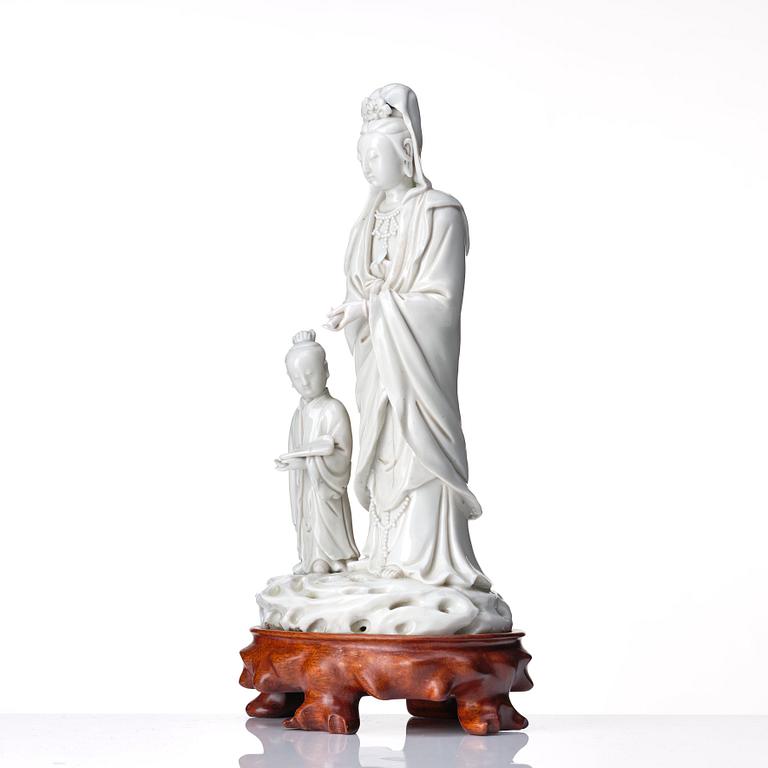 A blanc de chine figure of Guanyin and a servant, Qing dynasty, 19th Century.