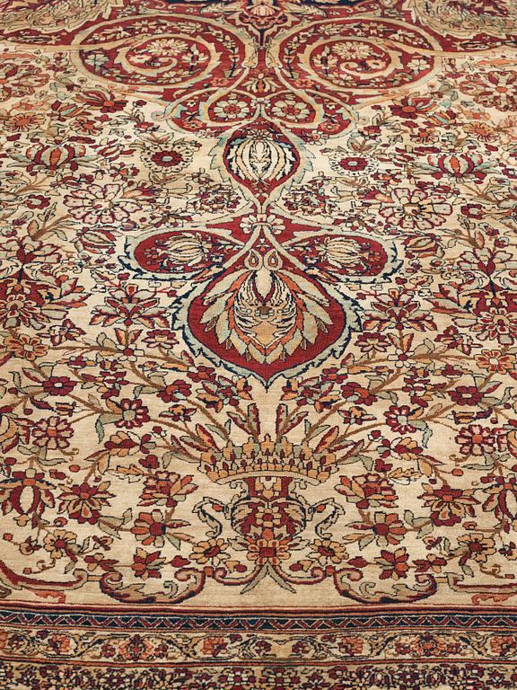 A carpet, an antique Kerman Laver, ca 677-688,5 x 510,5-526 cm.