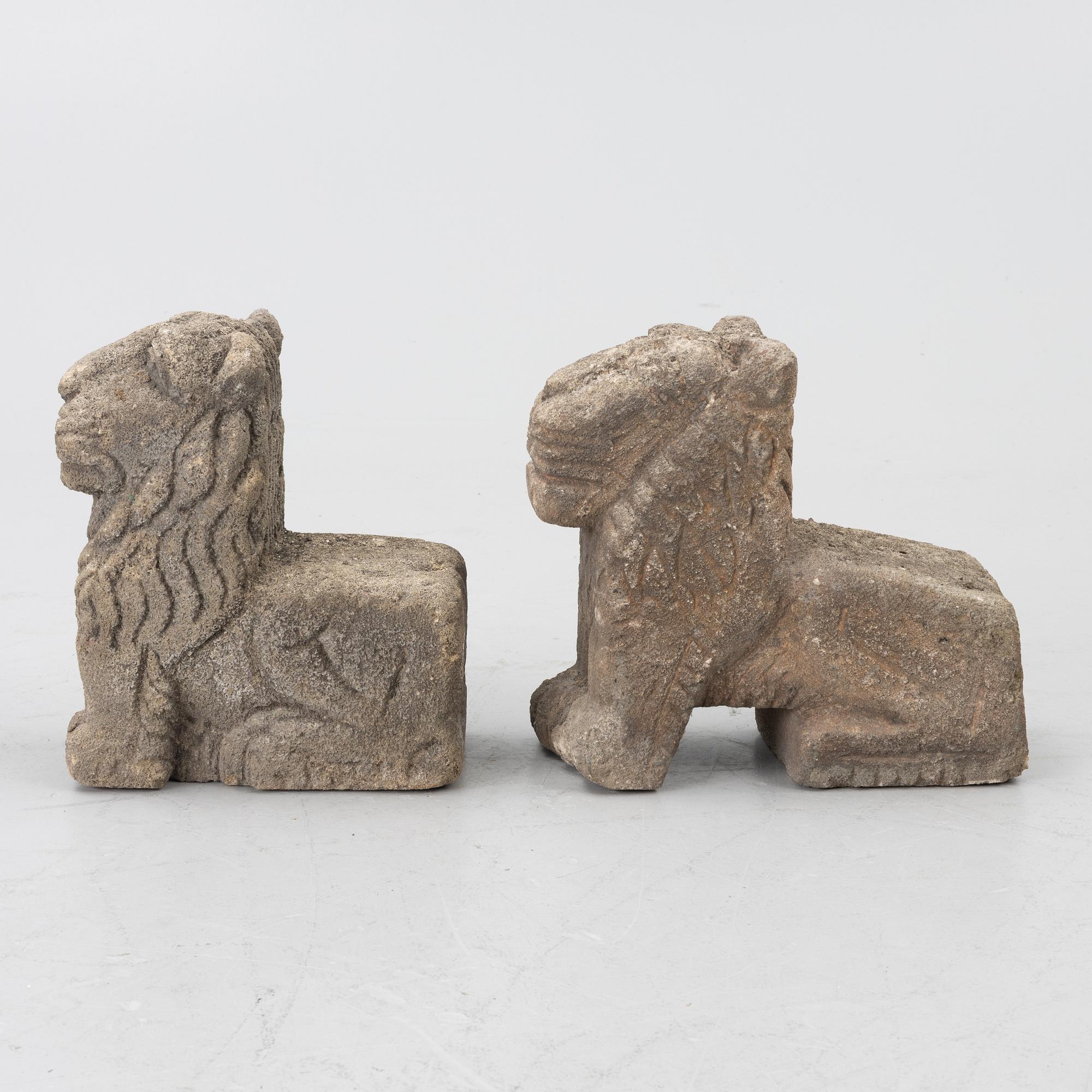 A set of two lion garden sculptures.