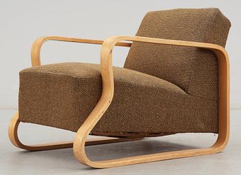 An Alvar Aalto laminated birch 'padded Paimio chair', upholstered in yellow and black fabric.