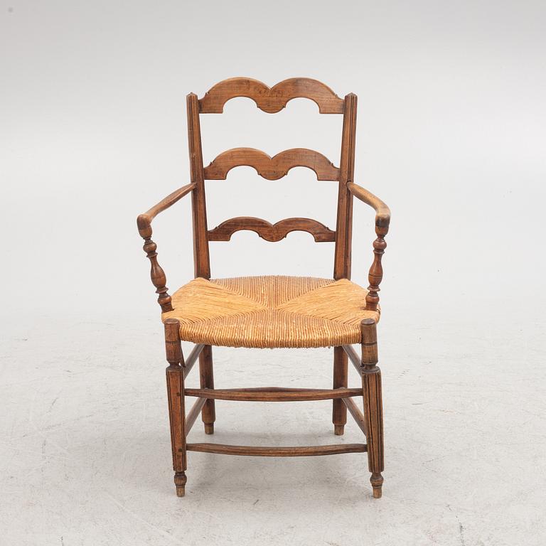 A French walnut open armchair, first part 19th century.