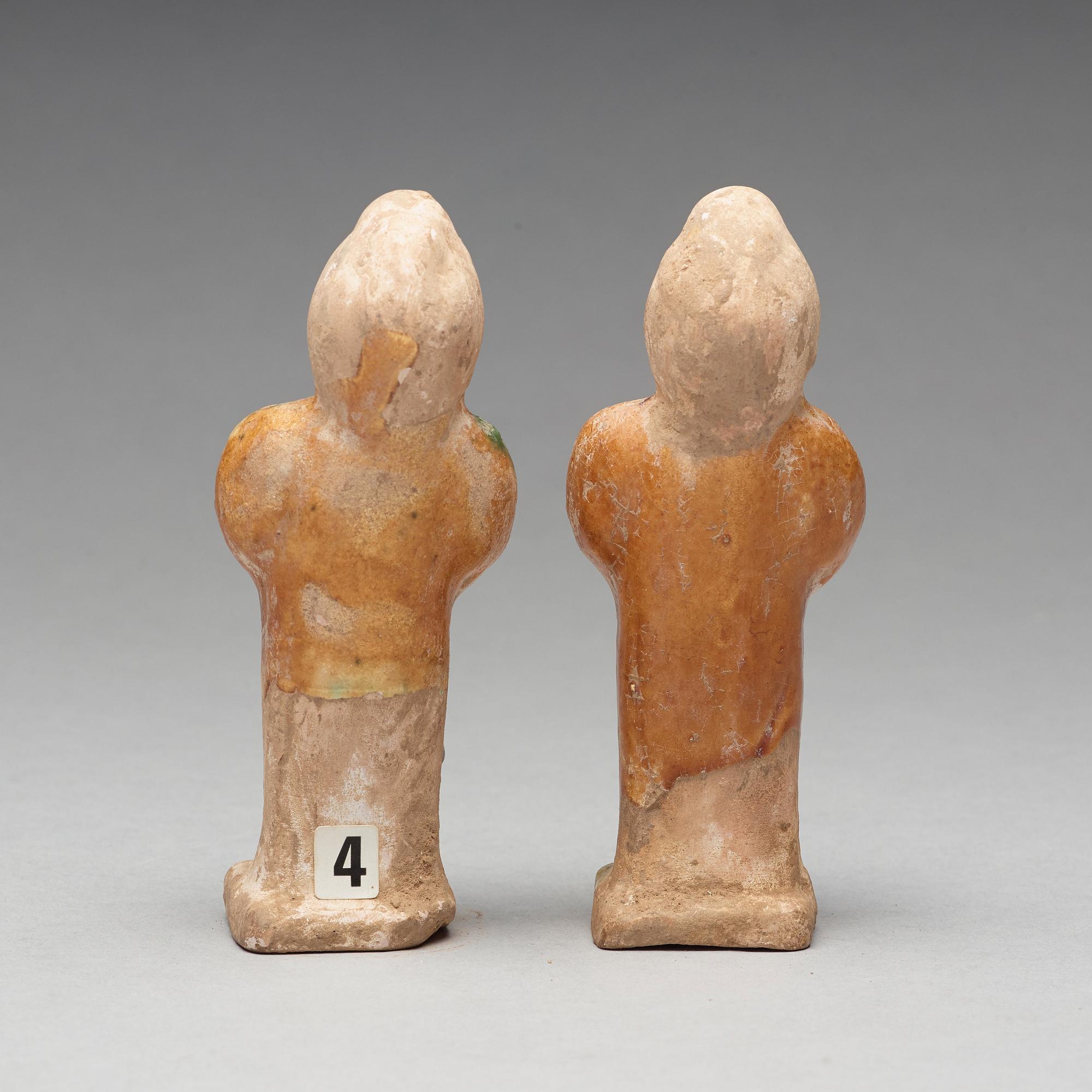 Two green and yellow glazed pottery figures of female attendants, Ming dynasty (1368-1644).