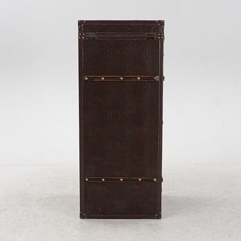 A leather suitcase-shaped bar cabinet.