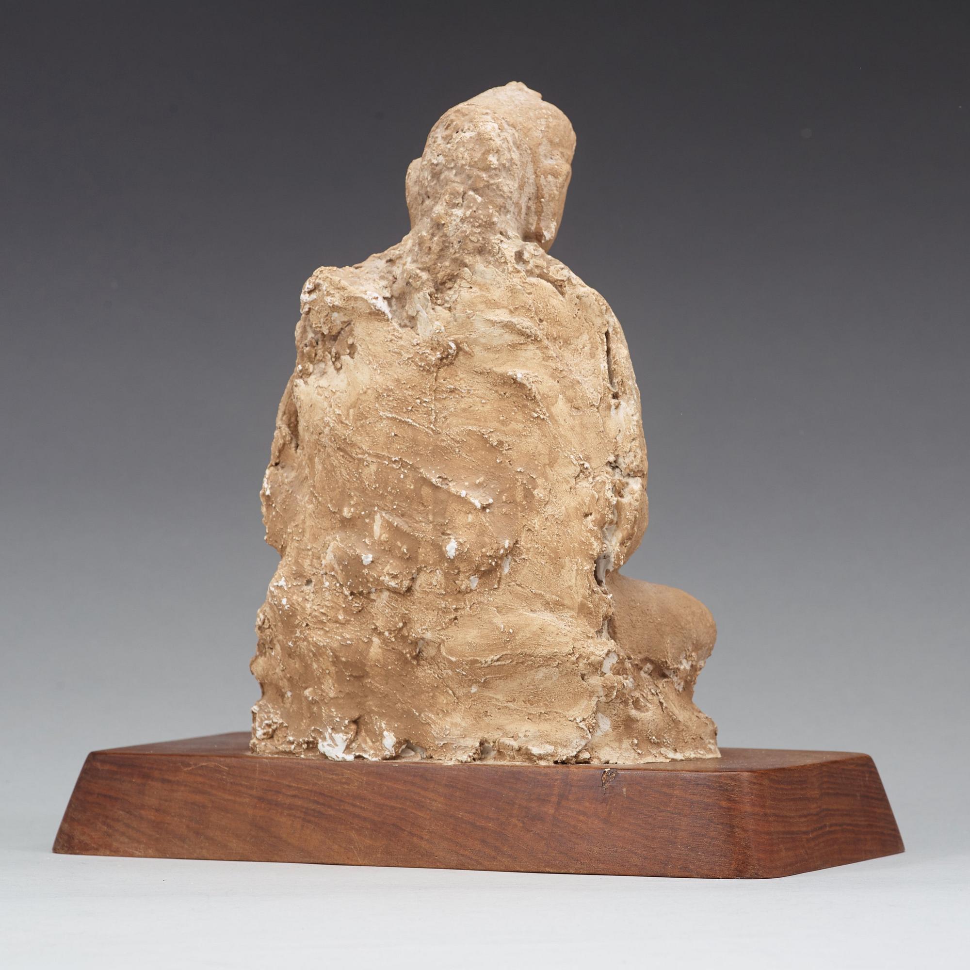 A stucco figure of a seated buddha, Gandhara, 2nd/3rd Century.