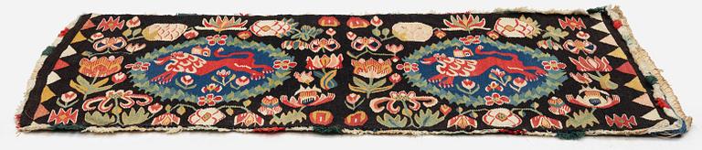 A cushion, 'Red Lion' (Rött Lejon), tapestry weave, c. 104 x 47 cm, Southwestern Scania, first part of the 19th century.