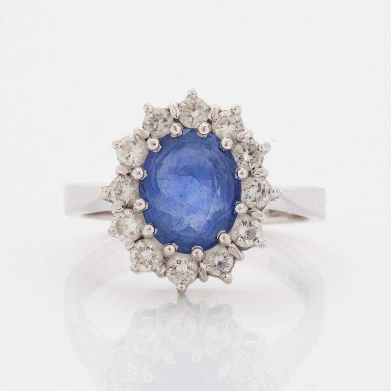 Oval faceted sapphire and brilliant-cut diamond ring.