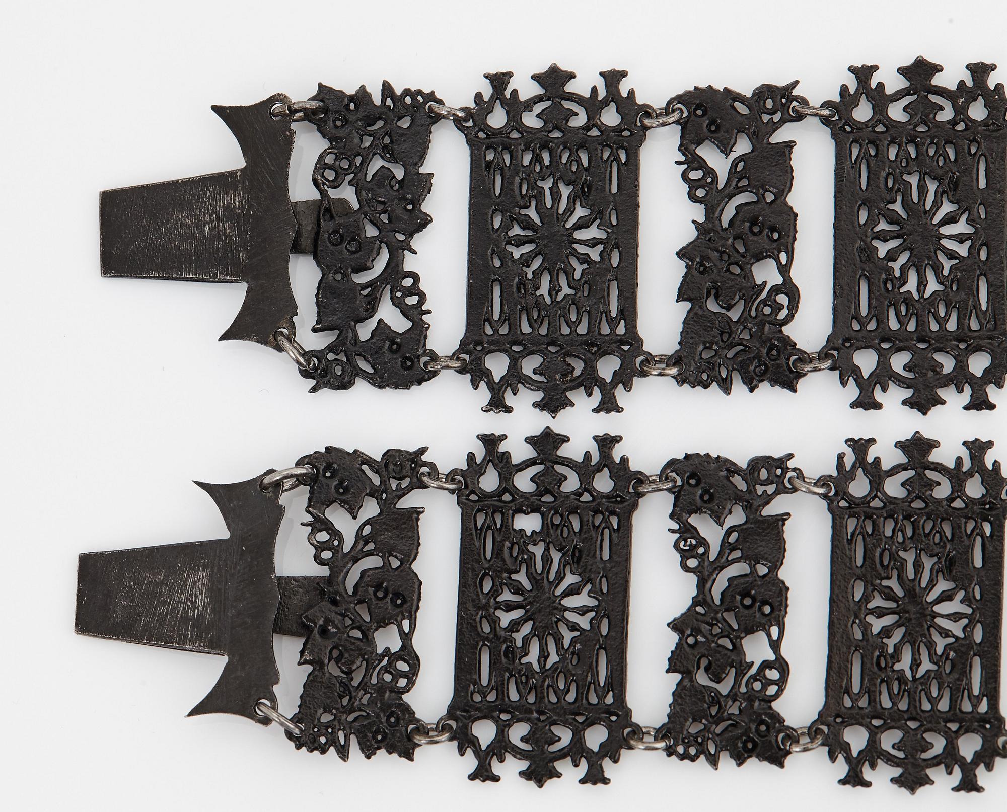 A Berlin steel and iron parure comprising a necklace, two bracelets and a brooch.