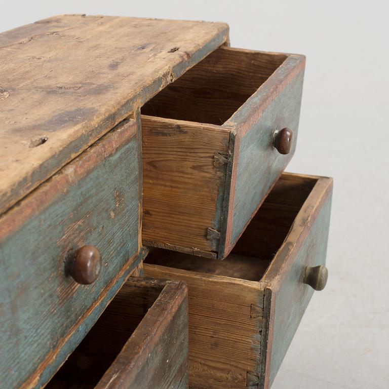 A folk art hanging cabinet with drawers 19th century.