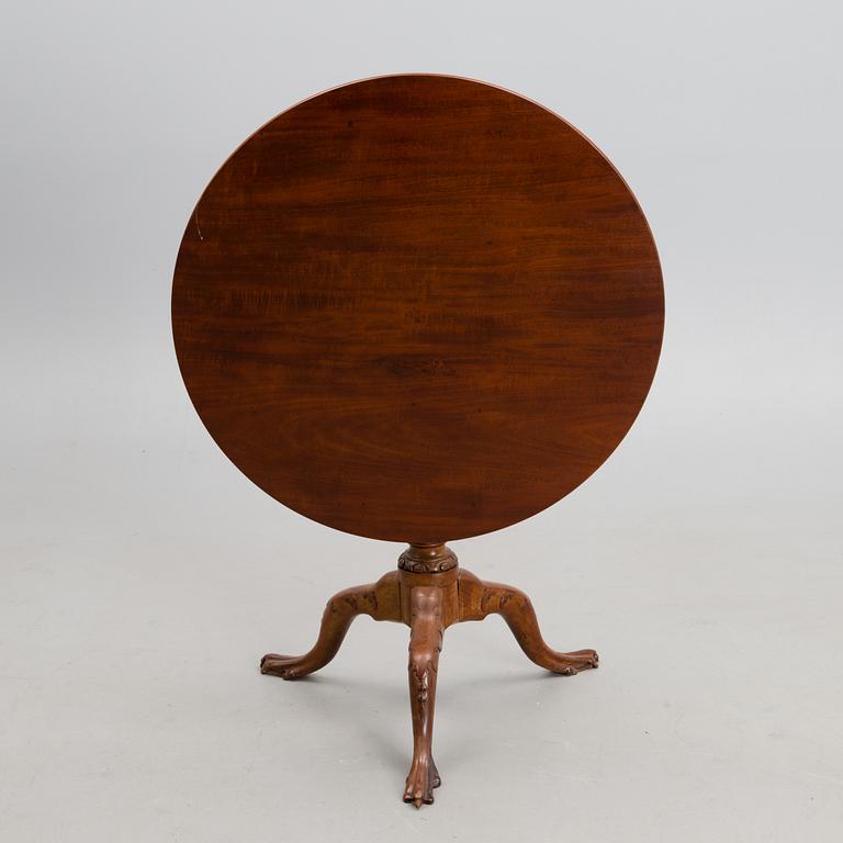 A 18th century mahogany English tilt top table.