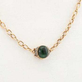 Necklace 18K gold with a cabochon-cut green tourmaline and rose-cut diamonds.