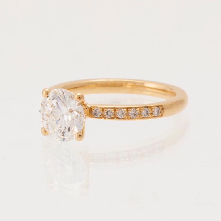 An 18K gold ring set with round brilliant-cut diamonds, GIA report.