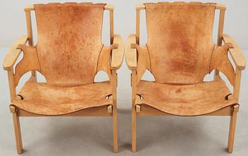 A pair of Carl-Axel Acking oak and beige leather armchairs, 'Trienna', Sweden 1950's-60's.