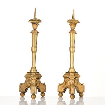 A pair of presumably Italian Empire ormolu candlesticks, early 19th century.