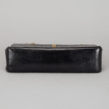 CHANEL, a quilted black leather 'Double Flap Bag'.
