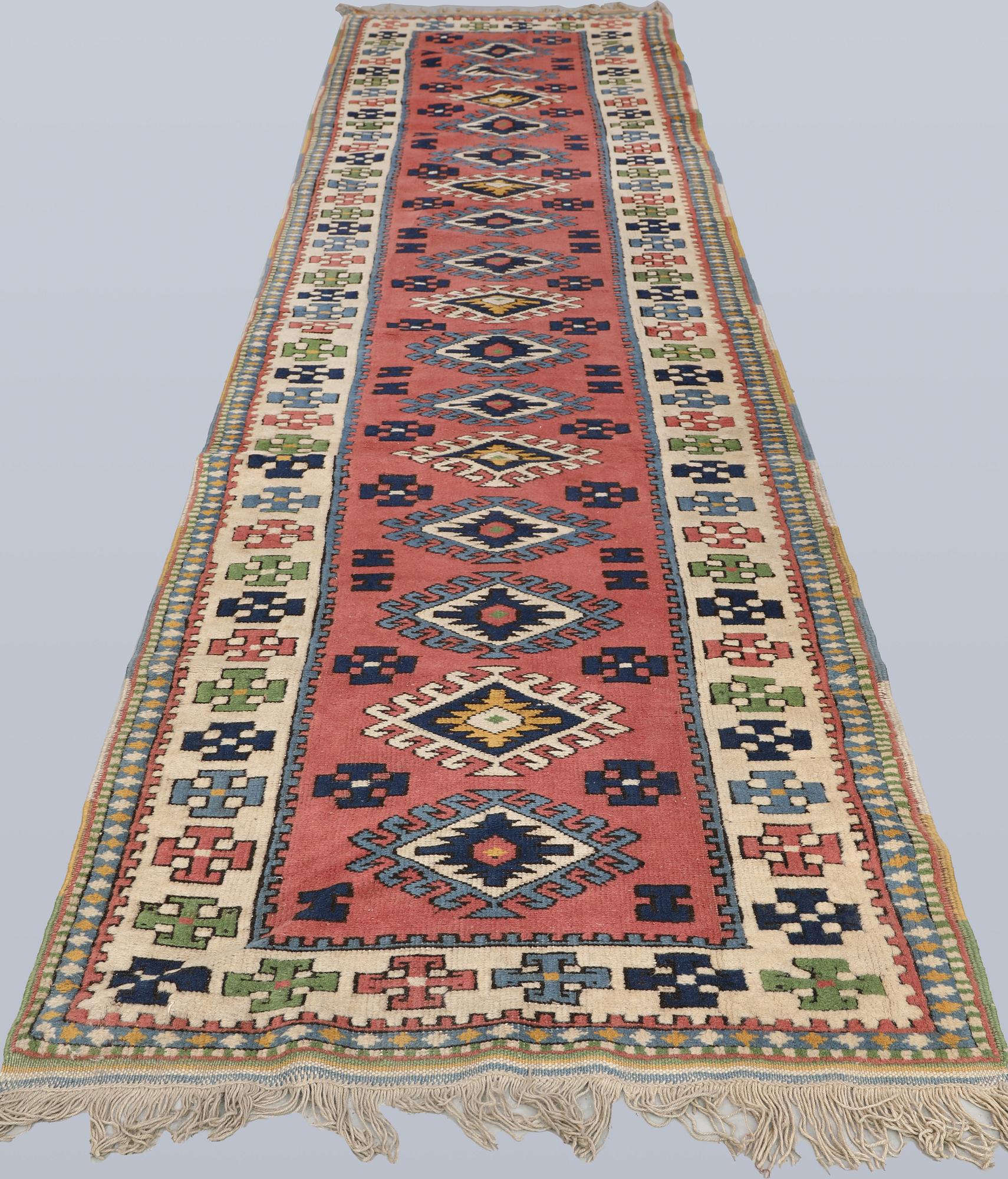 A semi-antique Kars runner, approx. 431 x 95 cm.