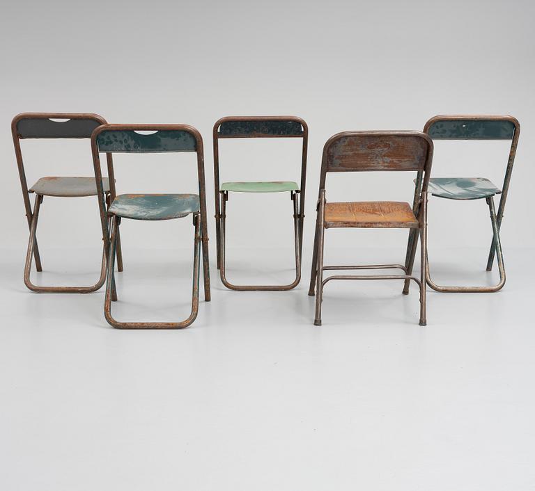 A set of five folding chairs.