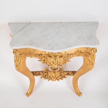 A mirror and console table from around the year 1900.