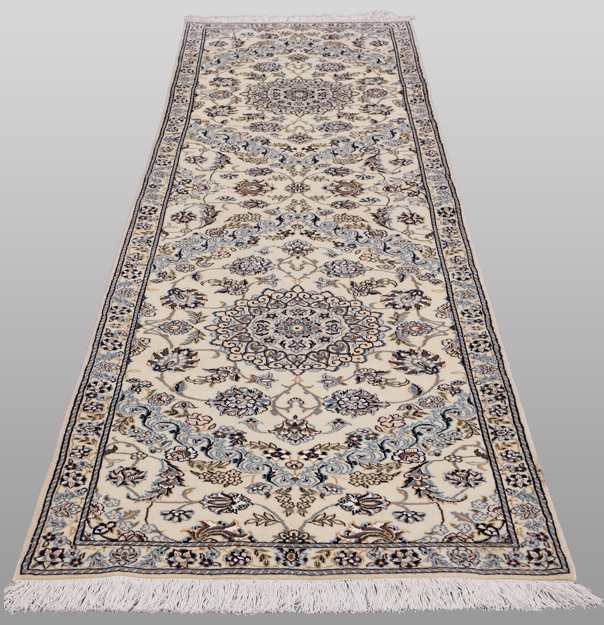 A Nain part silk runner carpet, 311 x 88 cm.