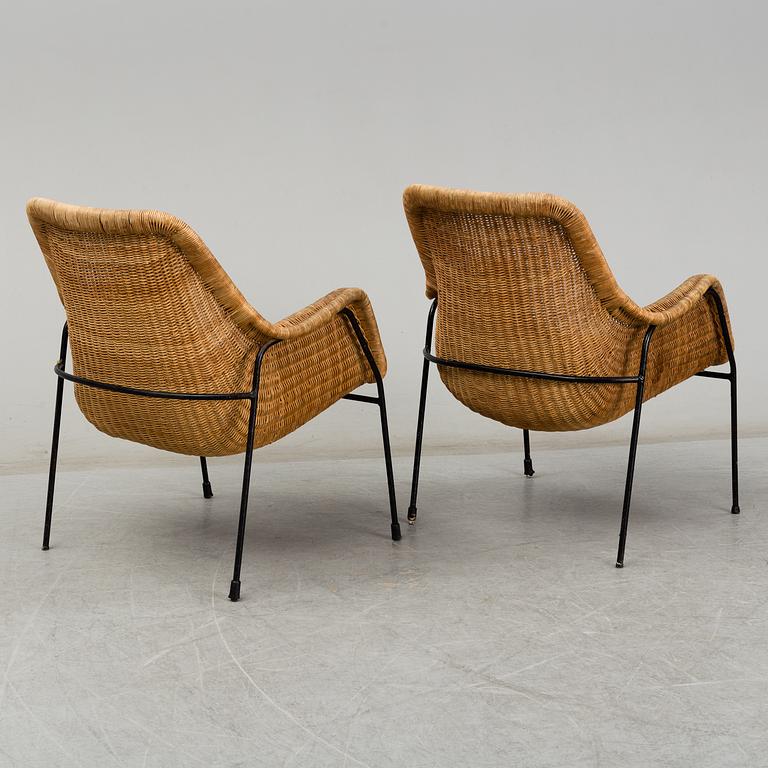 A 1950's pair of rattan easy chairs.