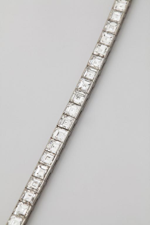 A platinum bracelet set with carré cut diamonds.