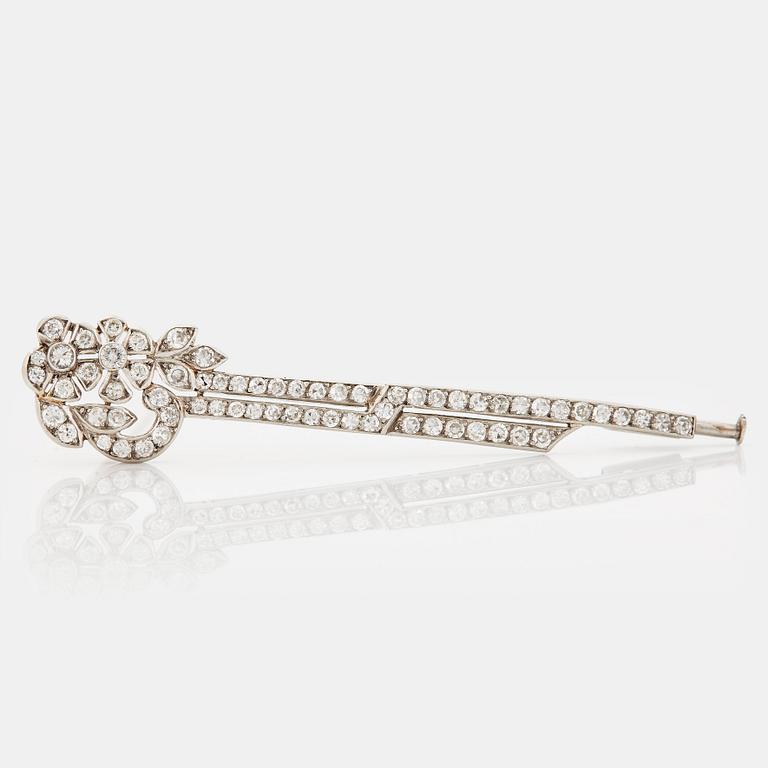 A platinum brooch set with round brilliant- and eight-cut diamonds.