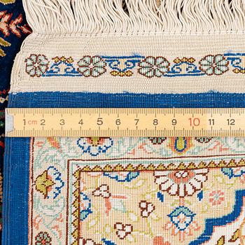 A semi-antique silk Hereke rug, West Anatolia, signed c. 107 x 72 cm.