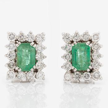 Earrings set with emerald-cut emeralds and brilliant-cut diamonds.