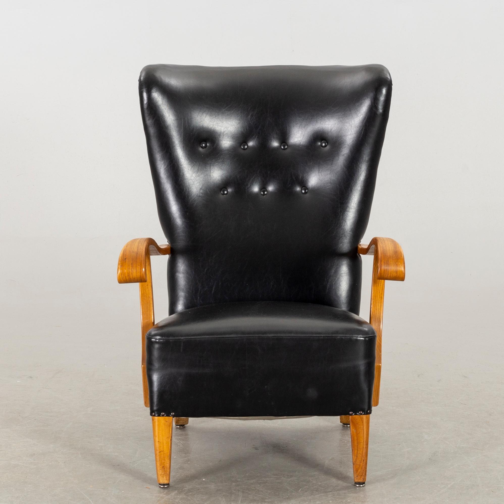A 1940's - 50's easy chair in black leather, Scandinavian.