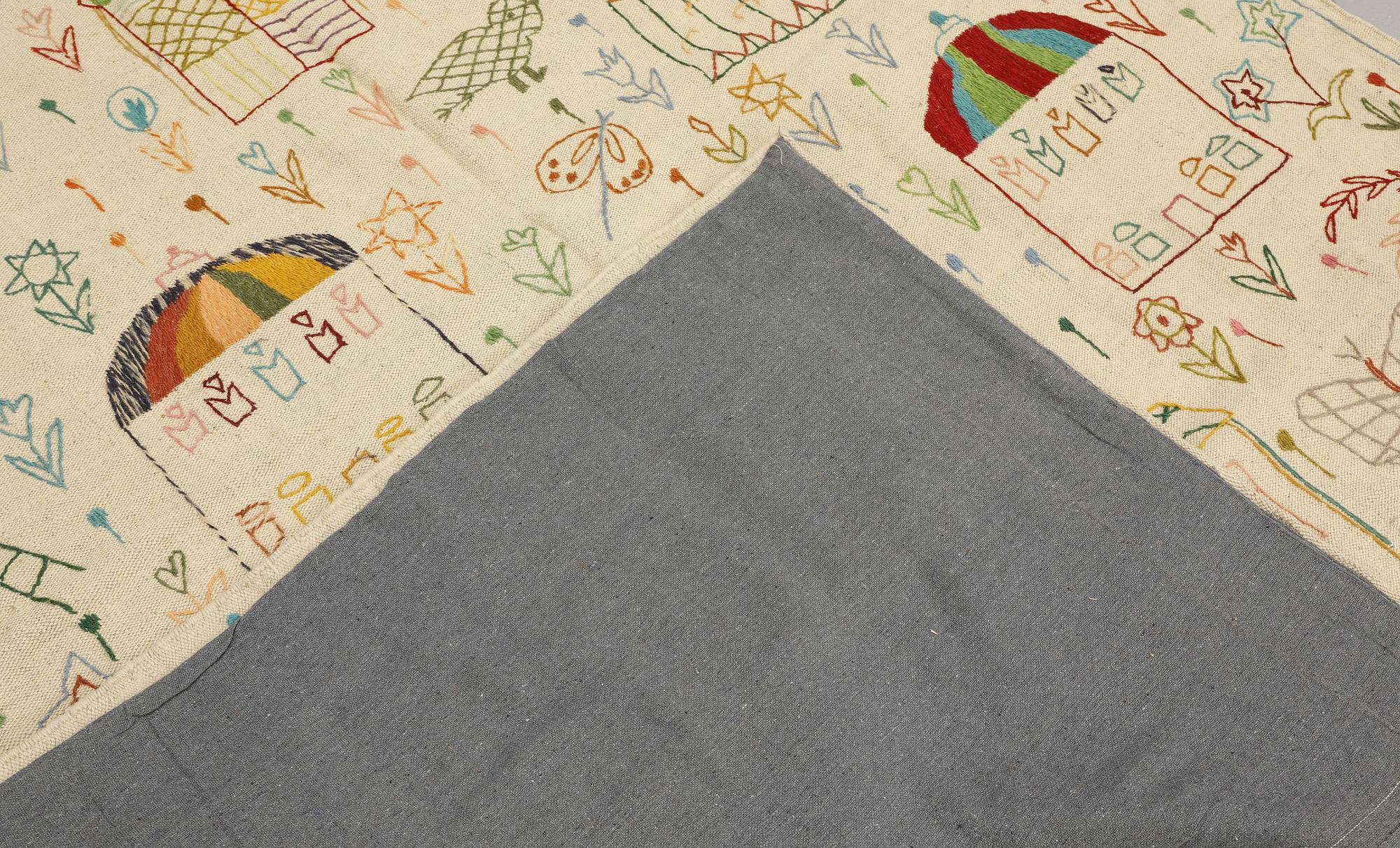 A hand-embroidered Kilim rug, c. 239 x 175 cm.