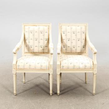 A pair of Gustavian style painted armchairs from around 1900.