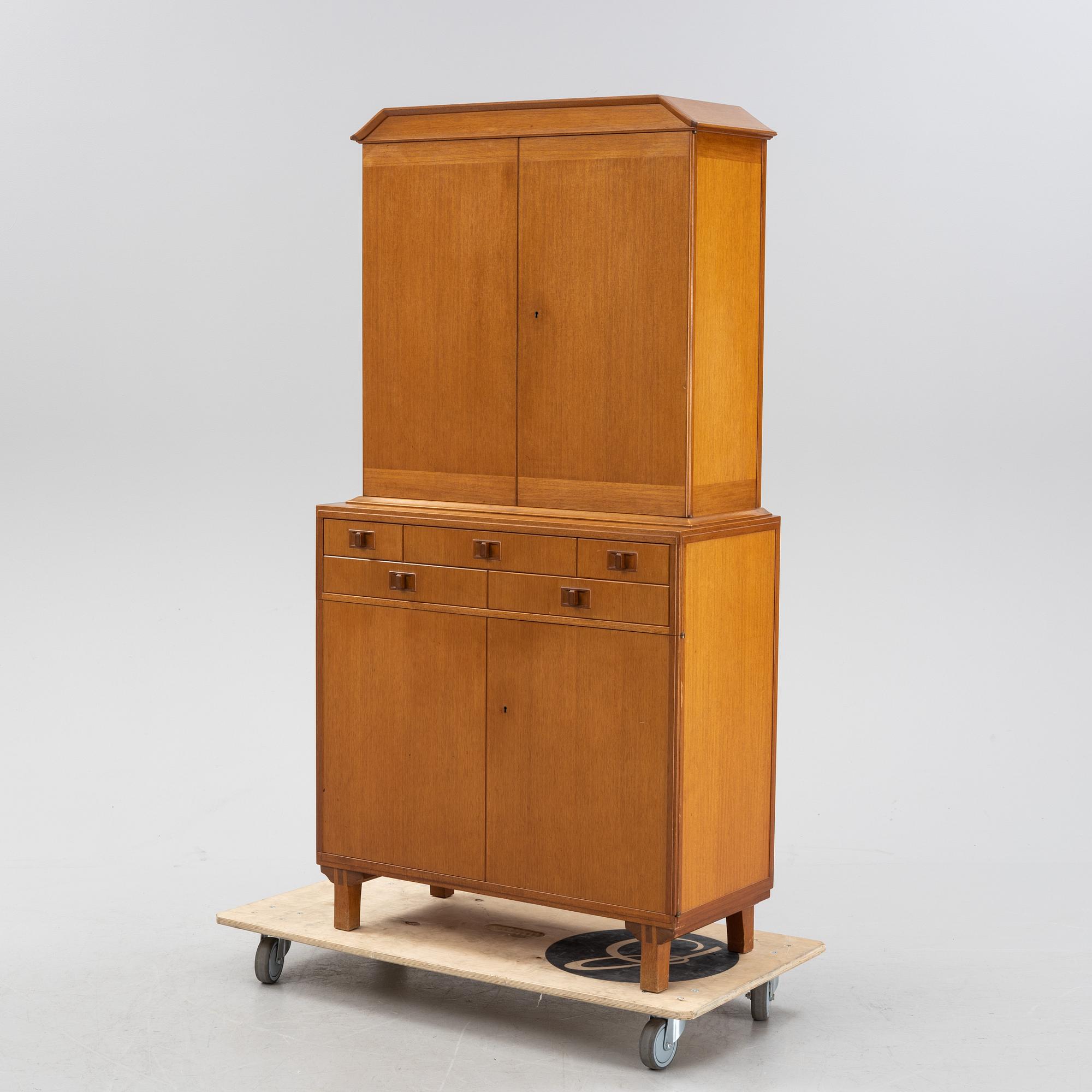 Carl Malmsten, a 'Mittens Rike' mahogany veneered cabinet, Åfors Möbelfabrik, Blomstermåla, dated 1957.