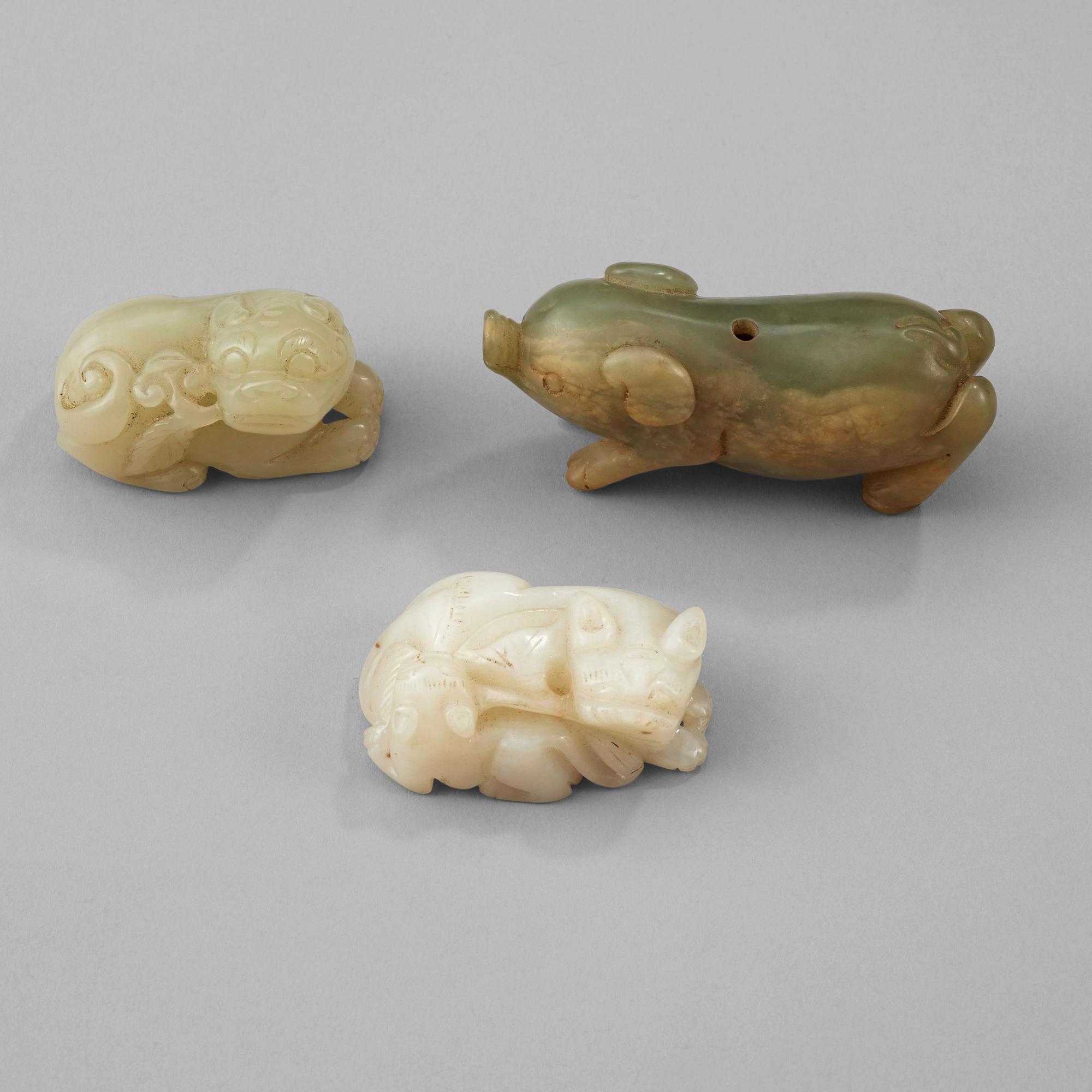 Three Chinese nephrite figure of two buddhist lions and a pig.