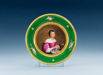 A french plate with a portrait of a young lady, 19th Century.
