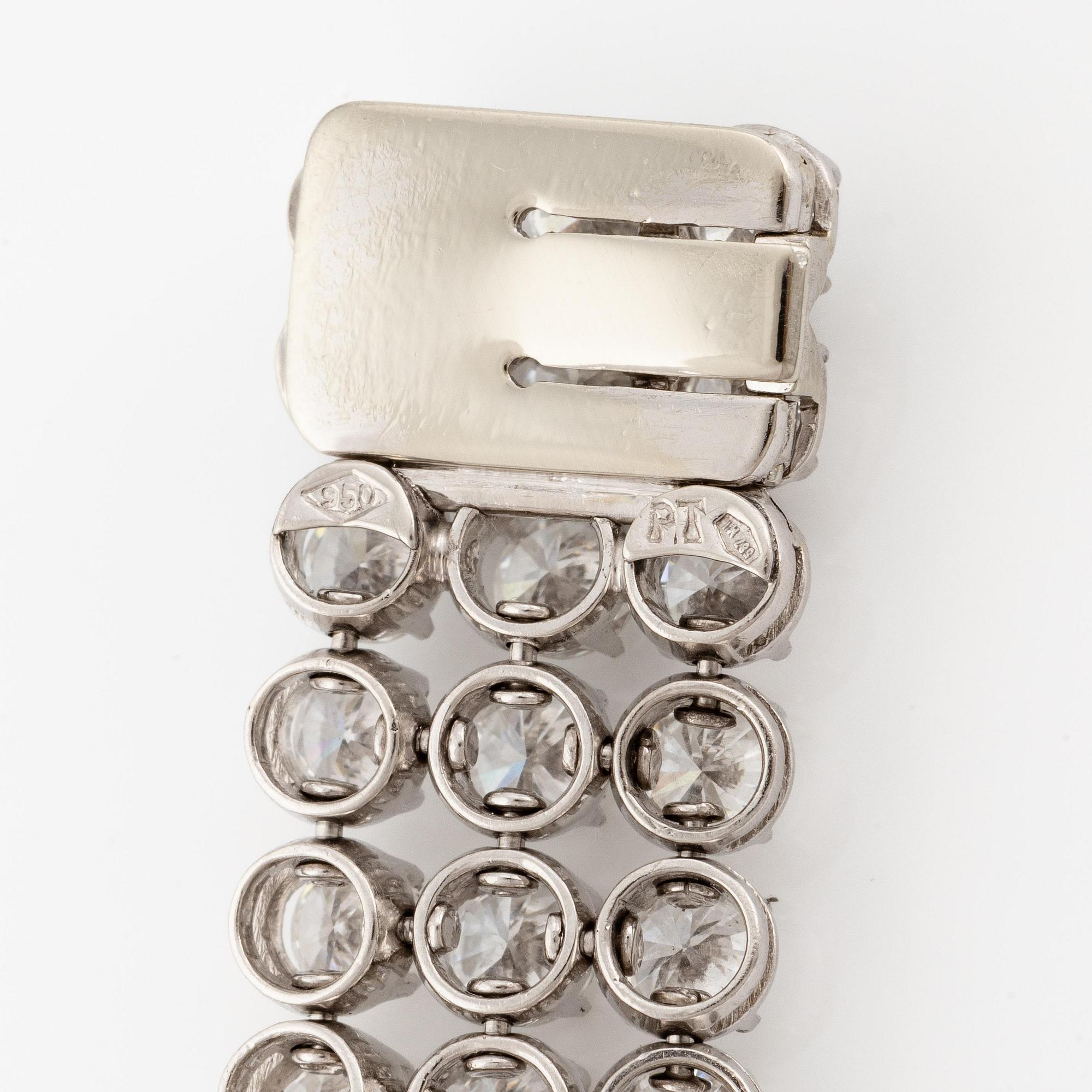 A platinum bracelet set with round brilliant-cut diamonds.