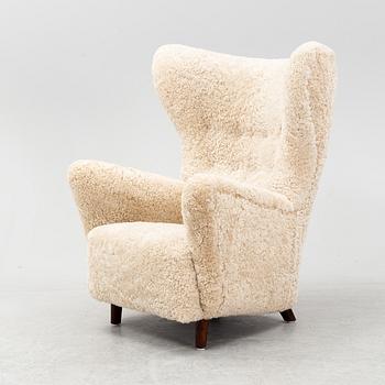 A sheepskin upholstered wing back lounge chair, 1940s.