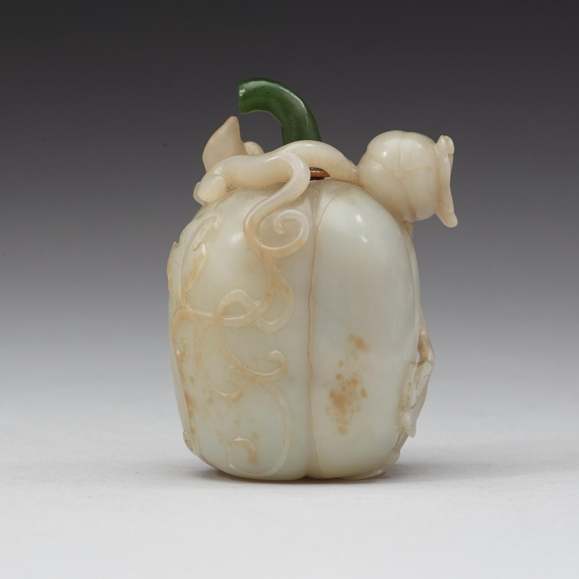 A nephrite snuff bottle with stopper in the shape of a melon, Qing dynasty (1644-1912).