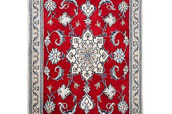 A Nain runner carpet, part silk, c. 300 x 78 cm.