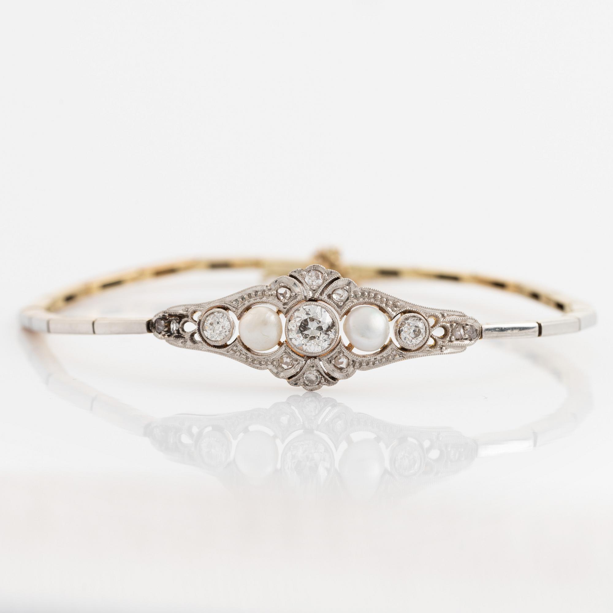 A 14K gold and platinum bracelet set with old- and rose-cut diamonds and pearls.