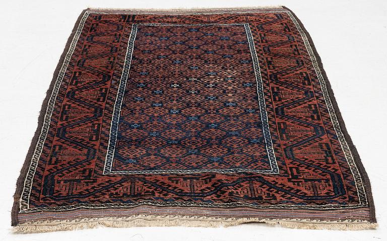 A semi-antique rug, baluch, including flat weave ca. 216 x 110 cm.