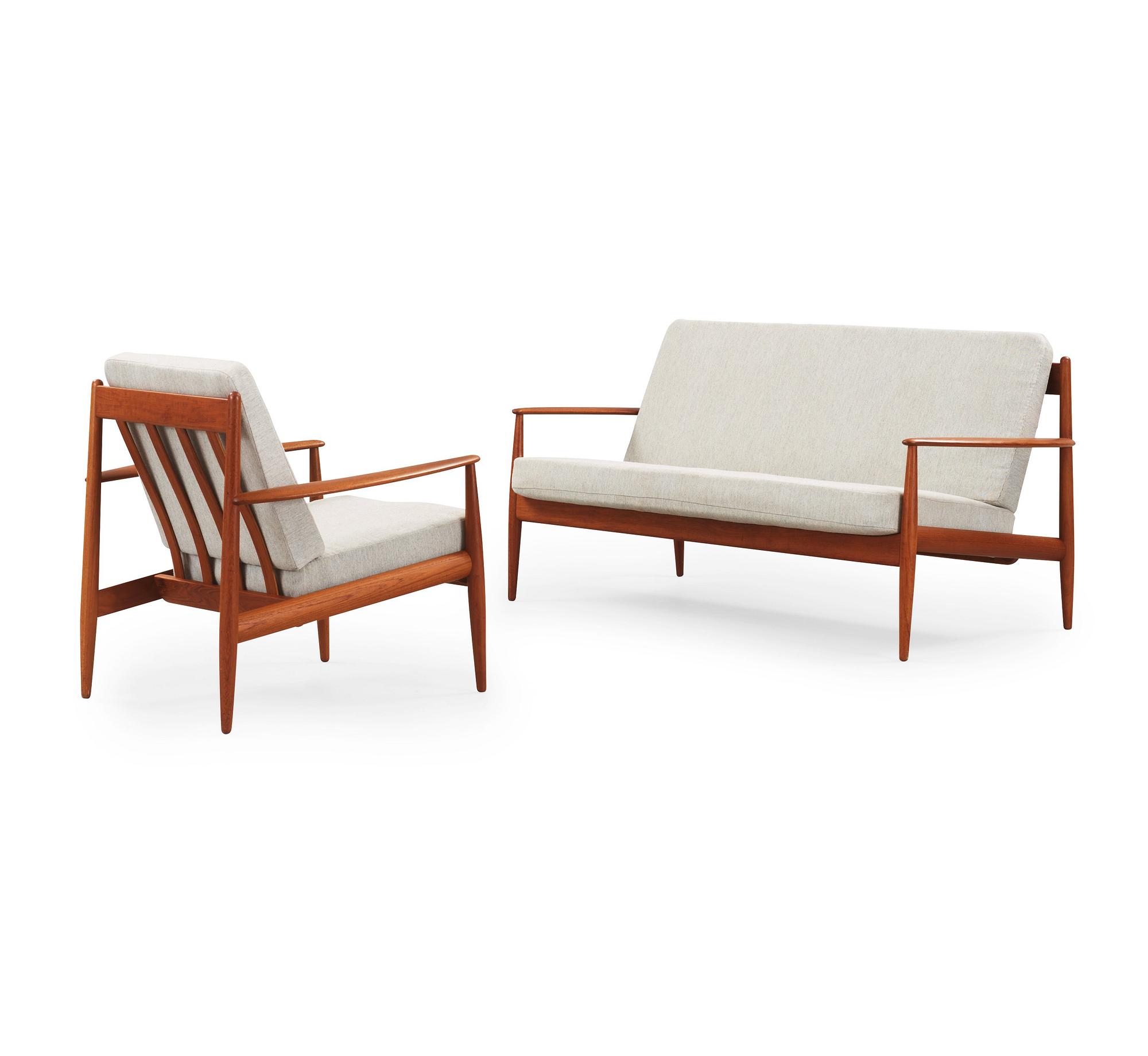 A Grete Jalk teak sofa and armchair, cusions upholstered in grey fabric, France & Daverkosen, Denmark 1960's.