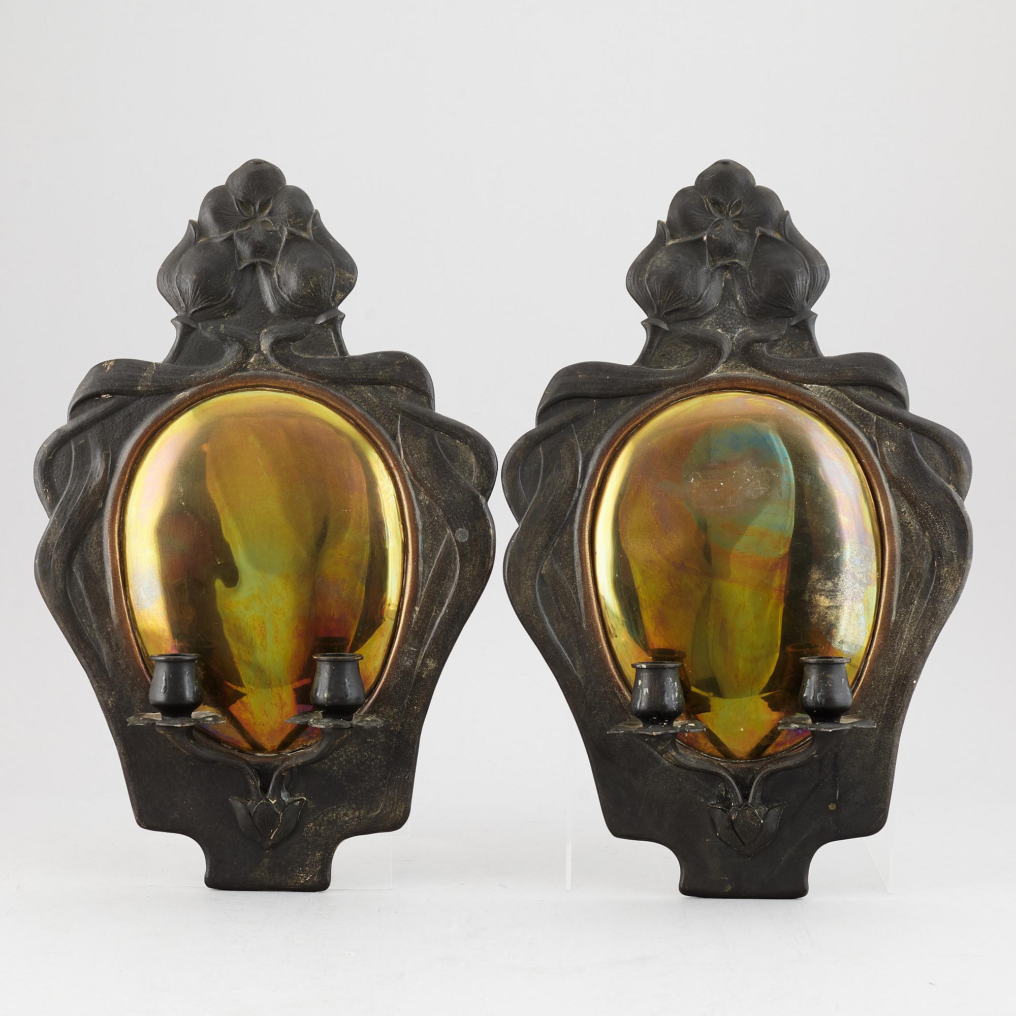 A pair of bronze and brass wall sconces from the early 20th century.