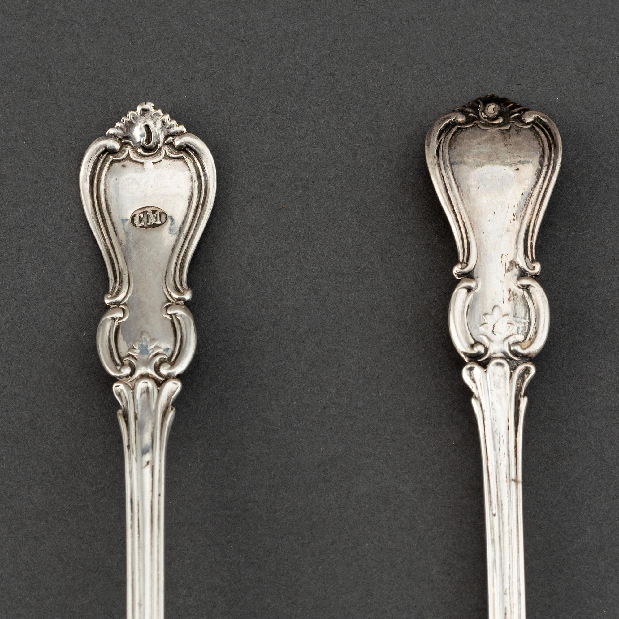 A pair of Swedish 19th century parcel-gilt silver caster-spoons, mark of PF Palmgren, Stockholm 1864.