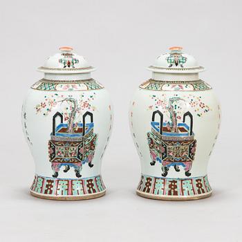 A pair of famille rose jars with covers, China, early 20th Century.