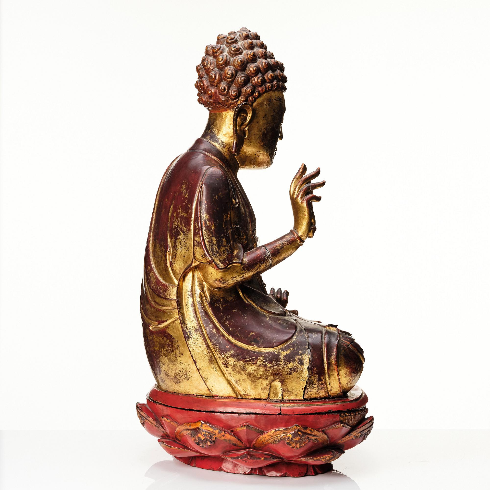 A large gilt and lacquered figure of a seated buddha, Qing dynasty, 19th Century.