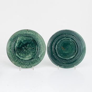 Josef Ekberg, 11 ceramic side plates and a dish, Gustavsberg, 1920's.