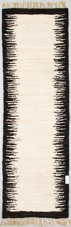 A sheepskin carper for Furcarpet. Circa 300x95 cm.