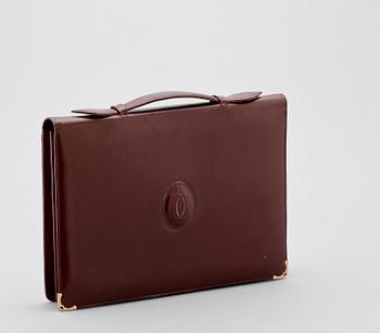 1455. A bordeaux leather brief-case by Cartier.