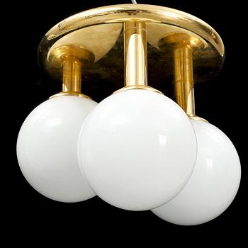 A contemporary brass and glass ceiling light.