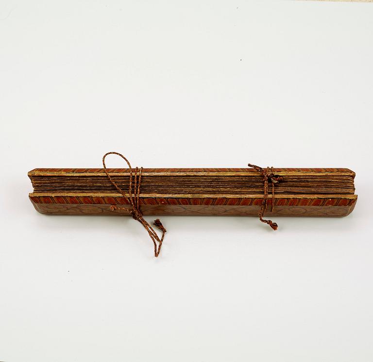 A palm-leaf manuscript bound between polychromed wooden boards, Sri Lanka 18th century.